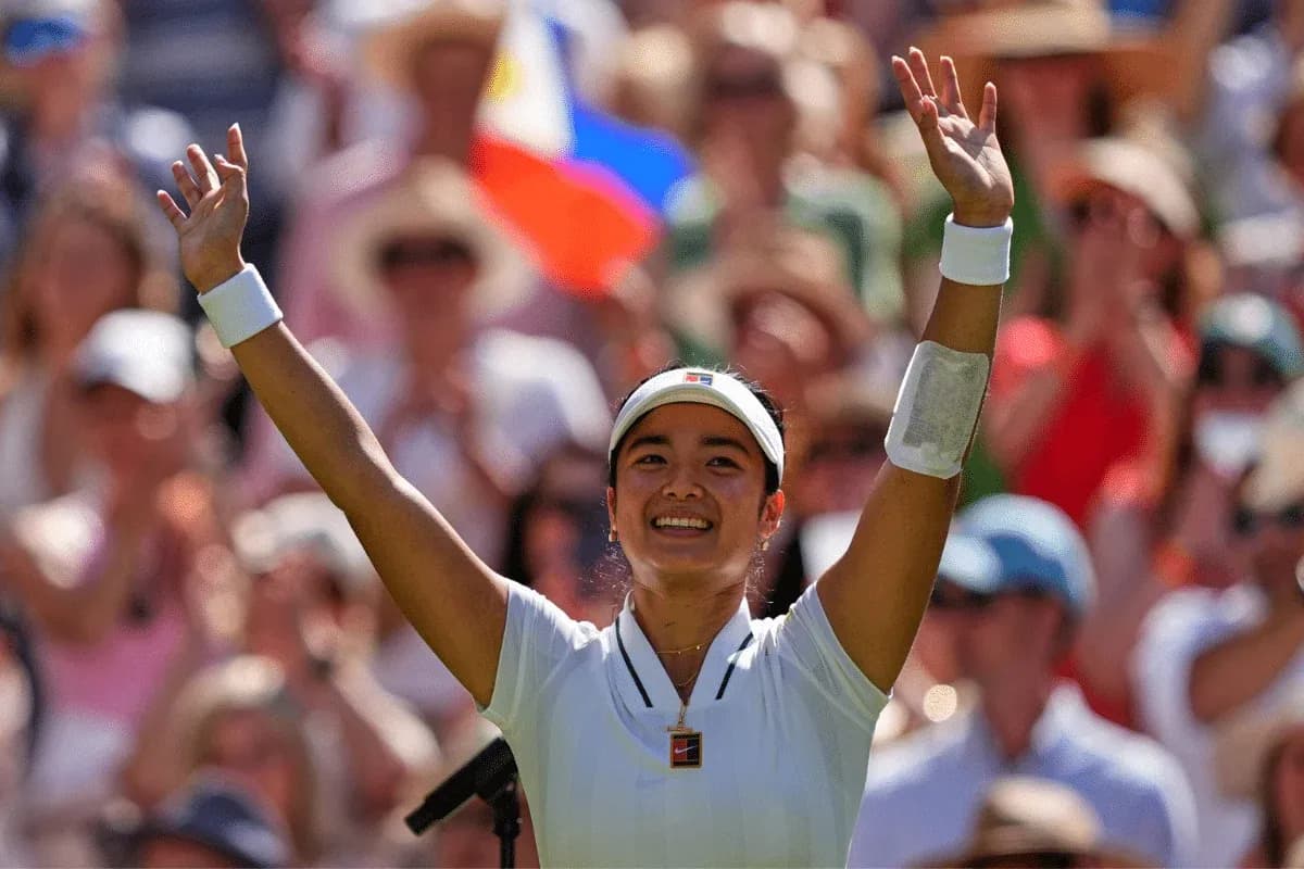 Tennis player celebrating with raised arms in crowd