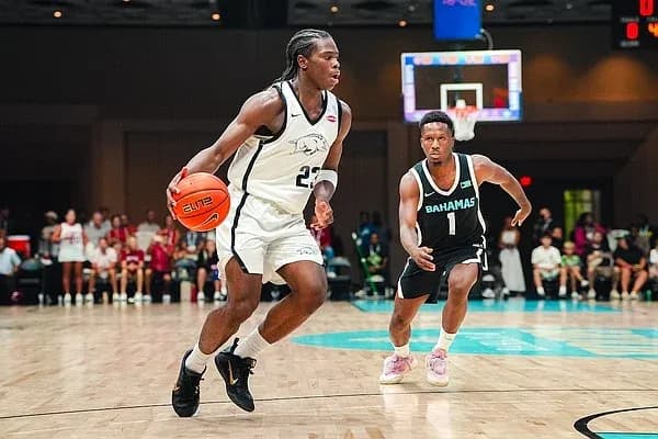 Basketball player dribbling while being guarded