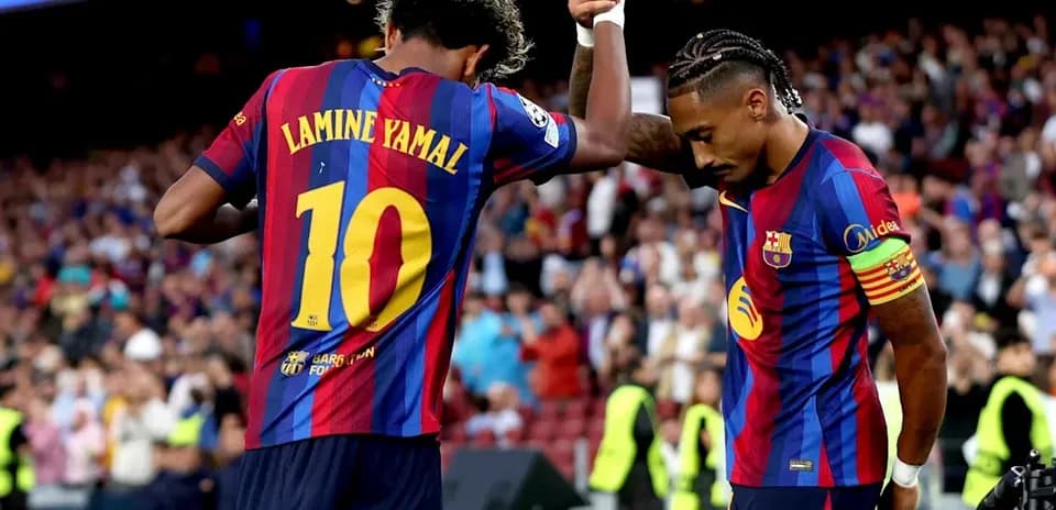 Two FC Barcelona players celebrating a goal