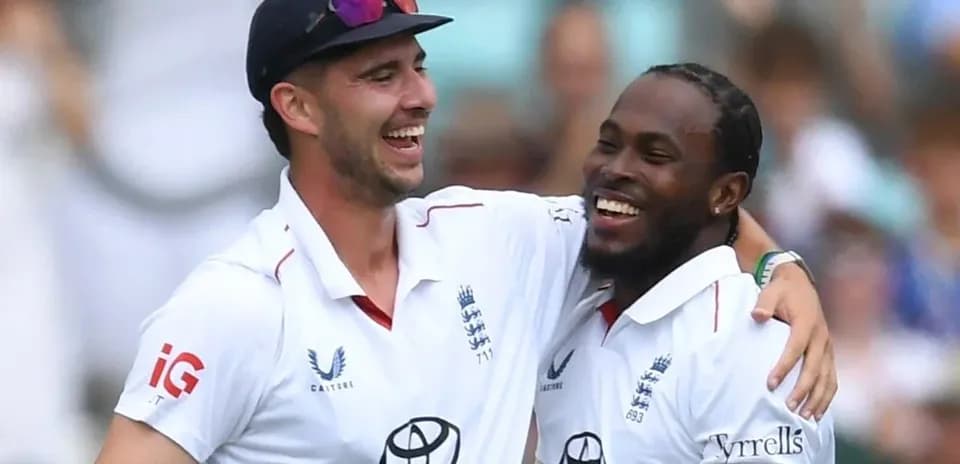 Two cricket players celebrating a wicket together