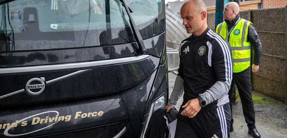 Trainers arriving by team bus in rainy weather