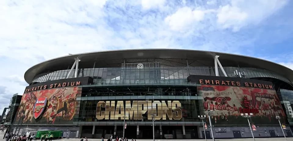 Emirates Stadium exterior with crowds and banners