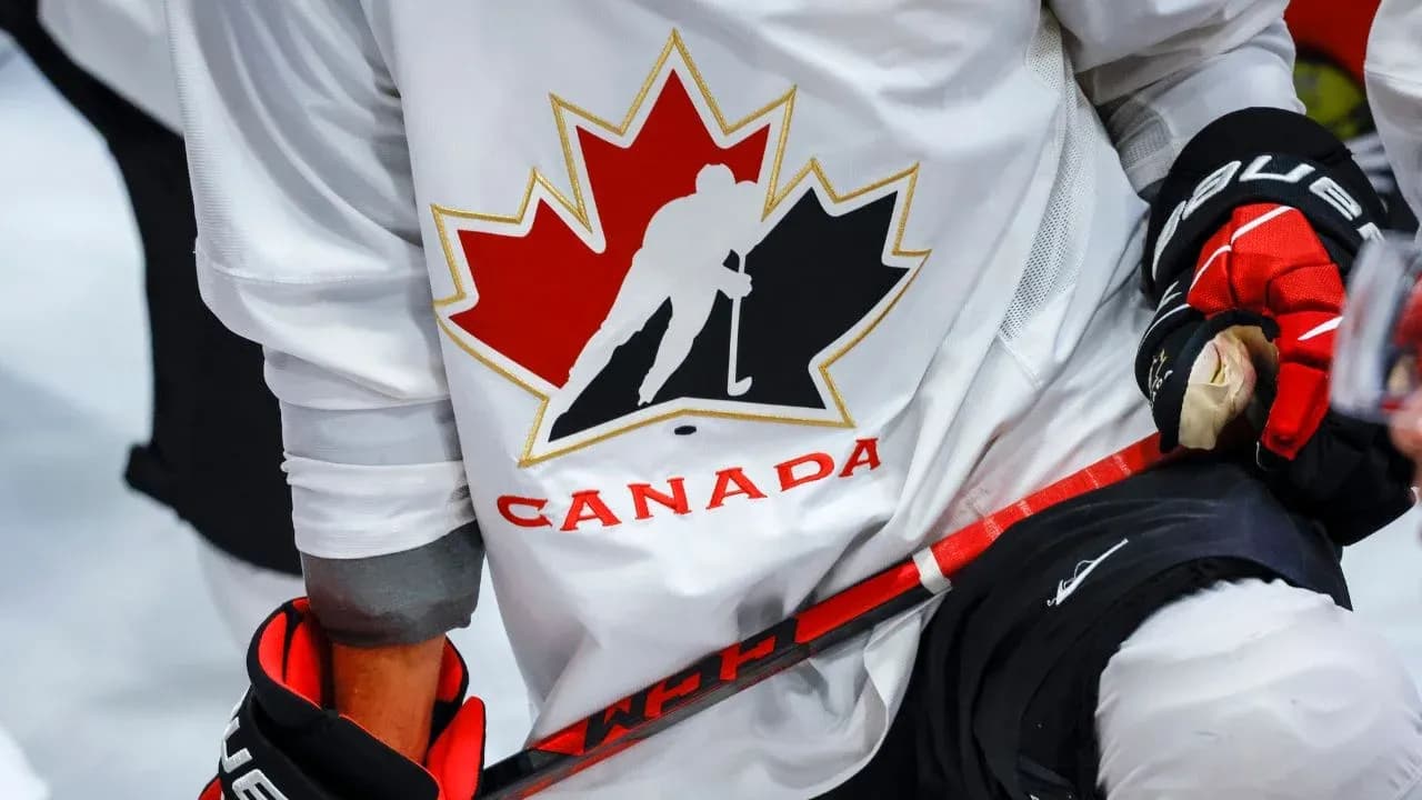 Hockey player wearing Canada jersey and gloves