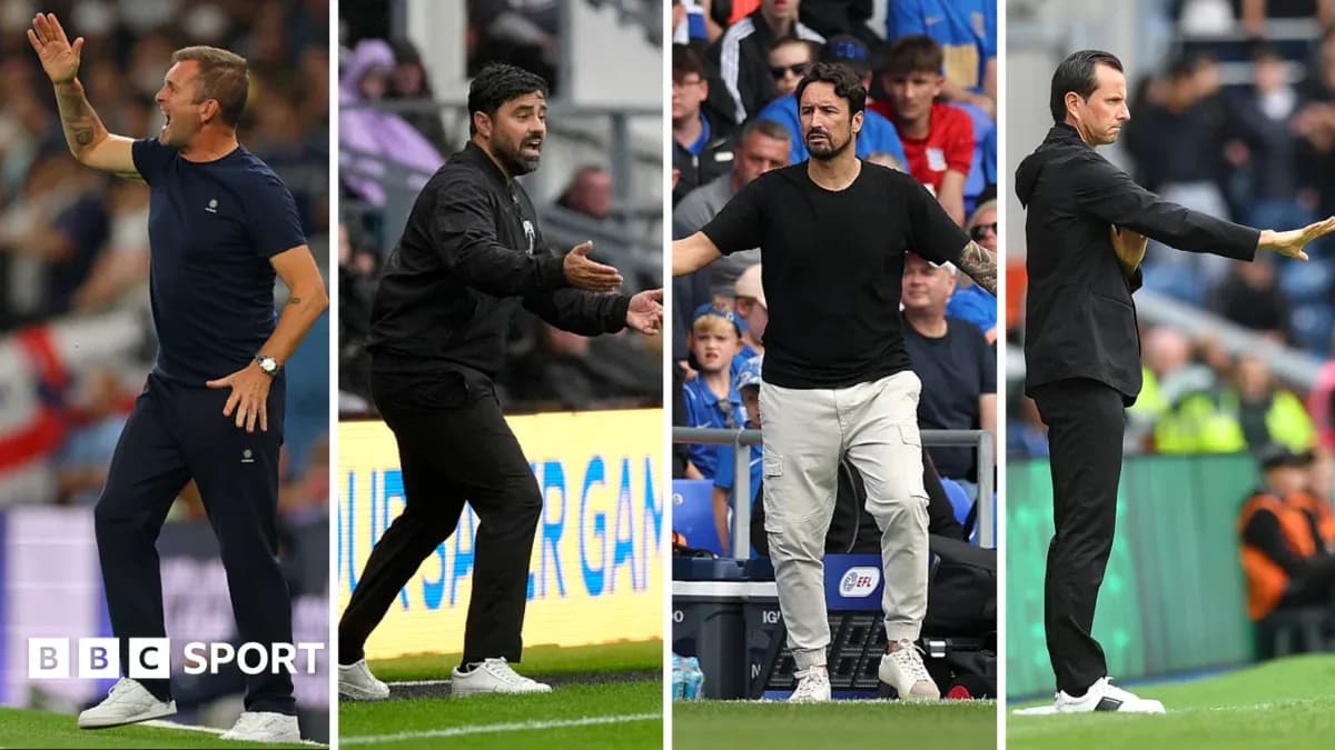 Four football managers giving instructions during match