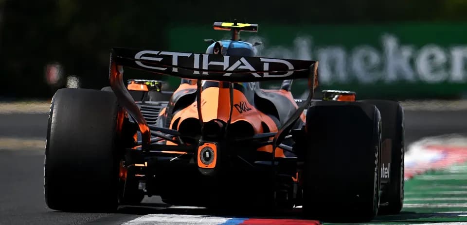 Formula 1 car racing on track with colorful curb