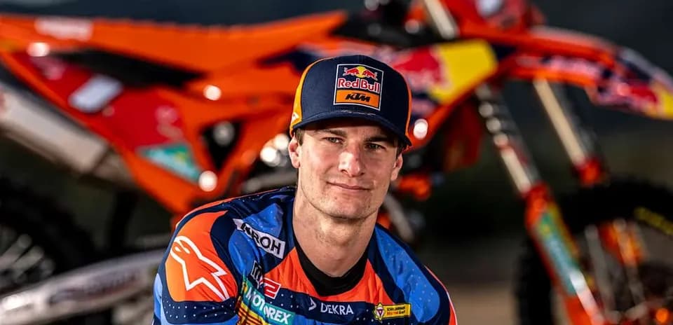 Motocross rider posing with KTM motorcycle