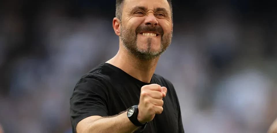 Coach celebrating with clenched fist on the field