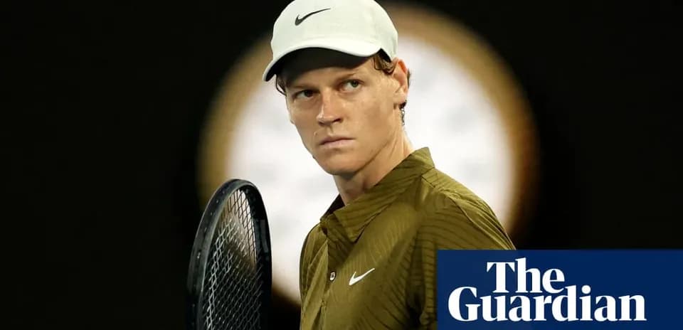 Tennis player holding racket, focused on match