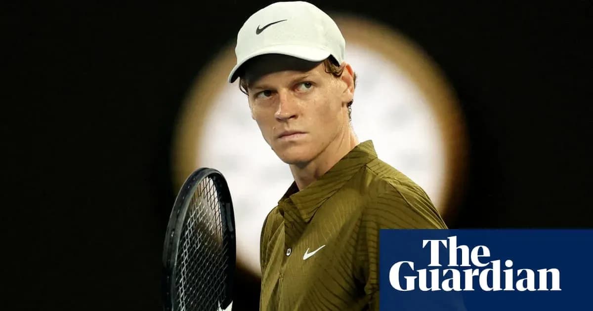Tennis player holding racket, focused on match
