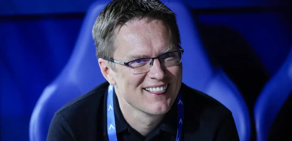 Smiling man seated in sports venue