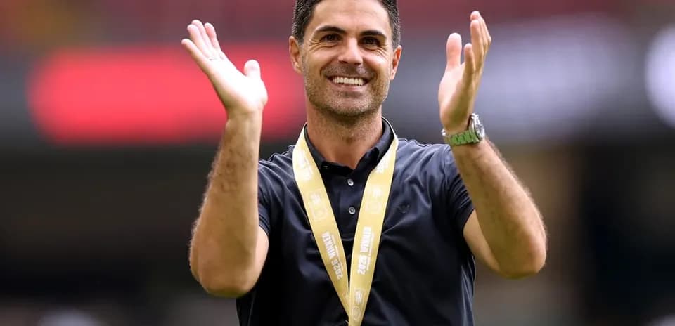 Coach celebrating with medal at stadium