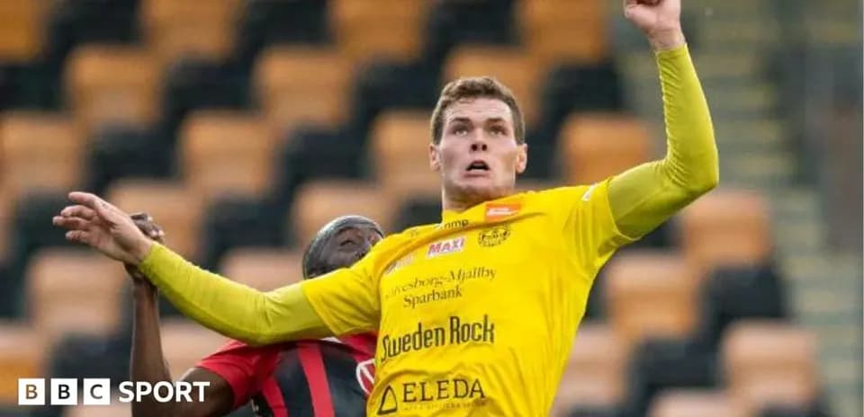 Player in yellow jersey competing for the ball