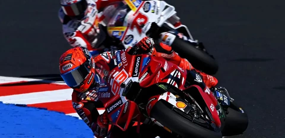 Ducati rider leaning into a turn during race