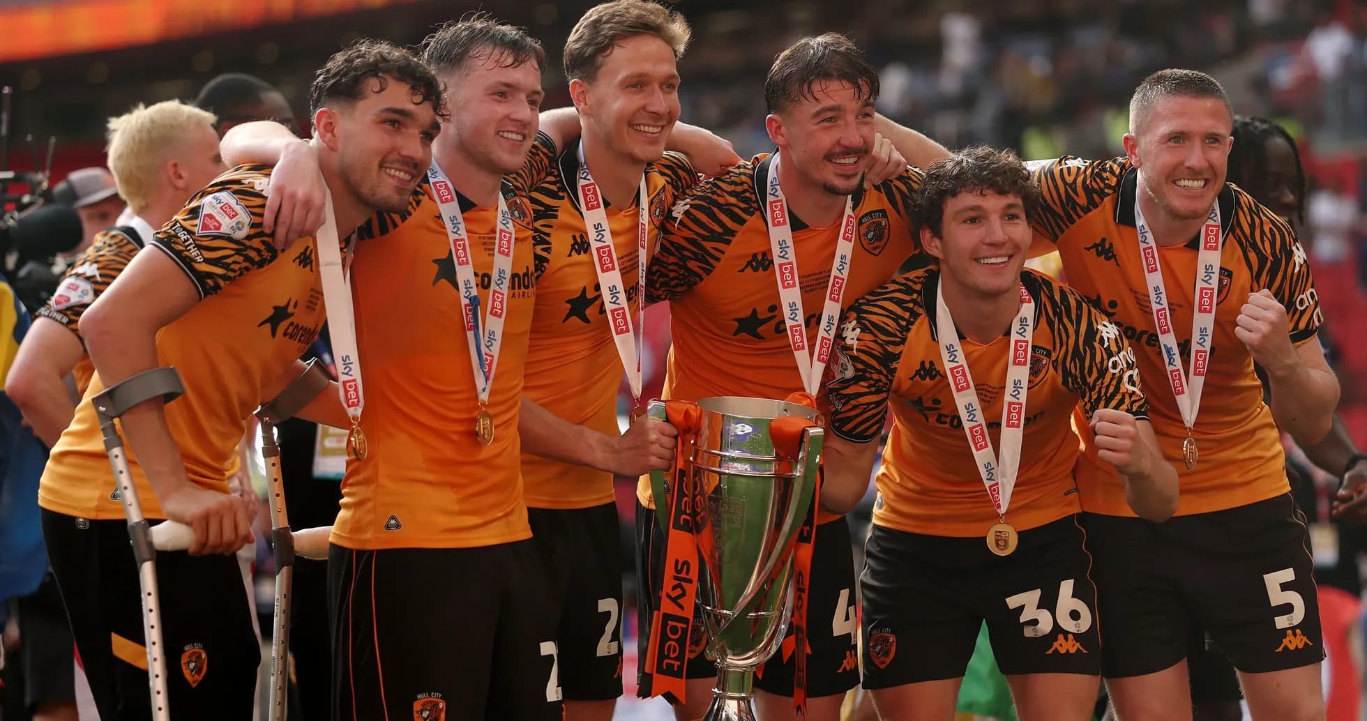 Hull City players celebrating with trophy and medals
