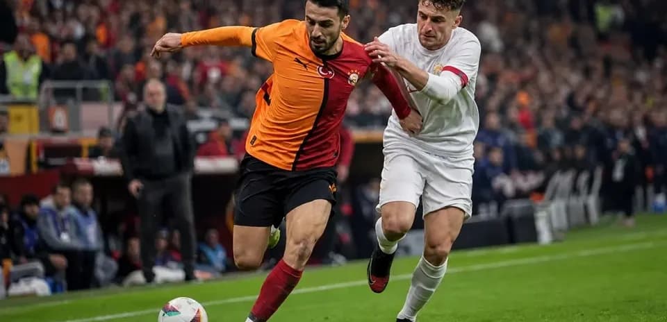 Galatasaray player being challenged by opponent during match