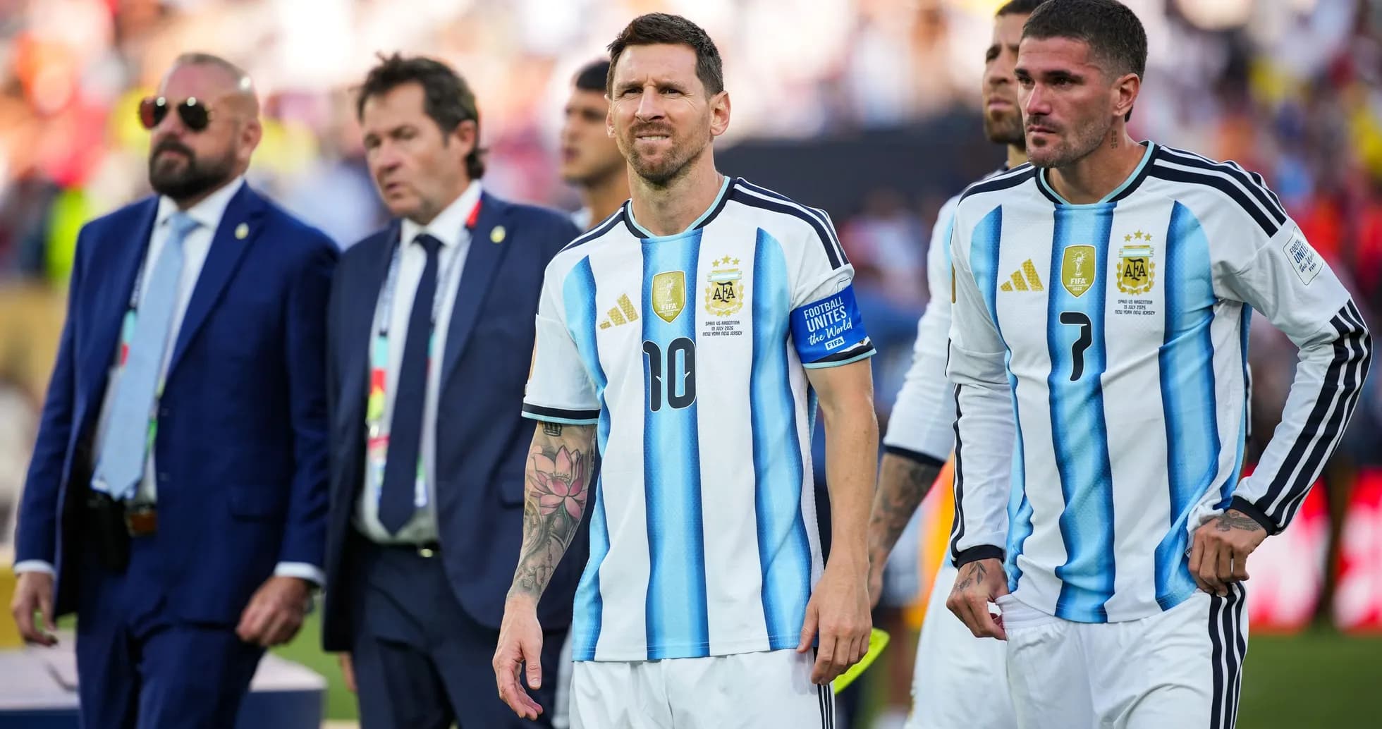 Lionel Messi and teammates walking off the field