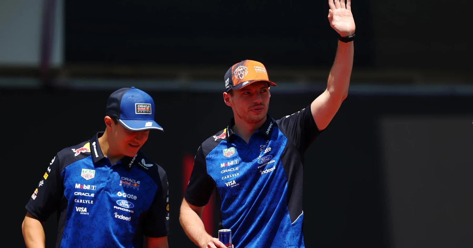 Formula 1 drivers waving during event appearance