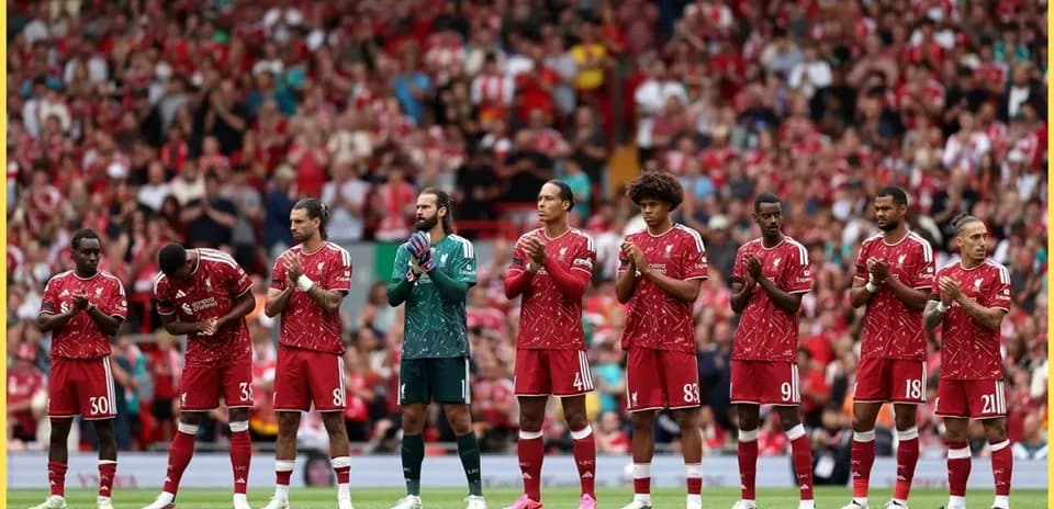 Liverpool players lined up applauding fans at Anfield