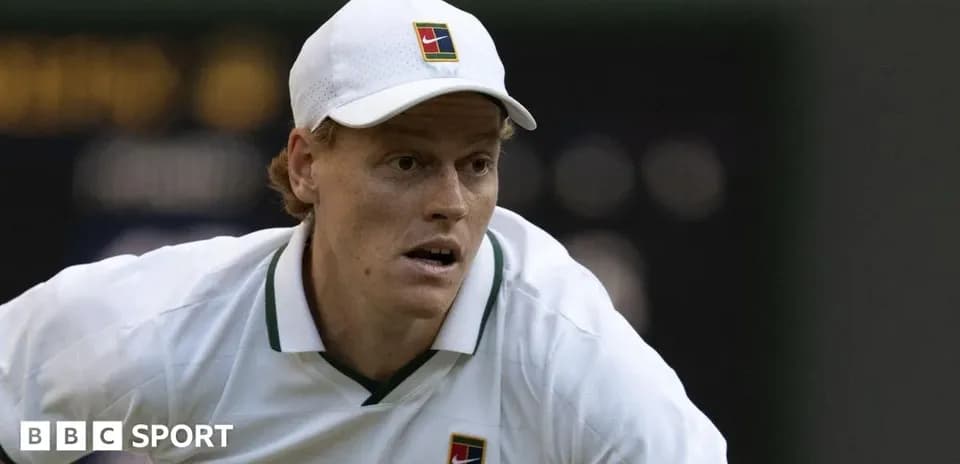 Tennis player preparing to serve during match