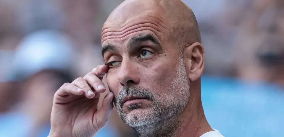 Football manager touching his eye during match