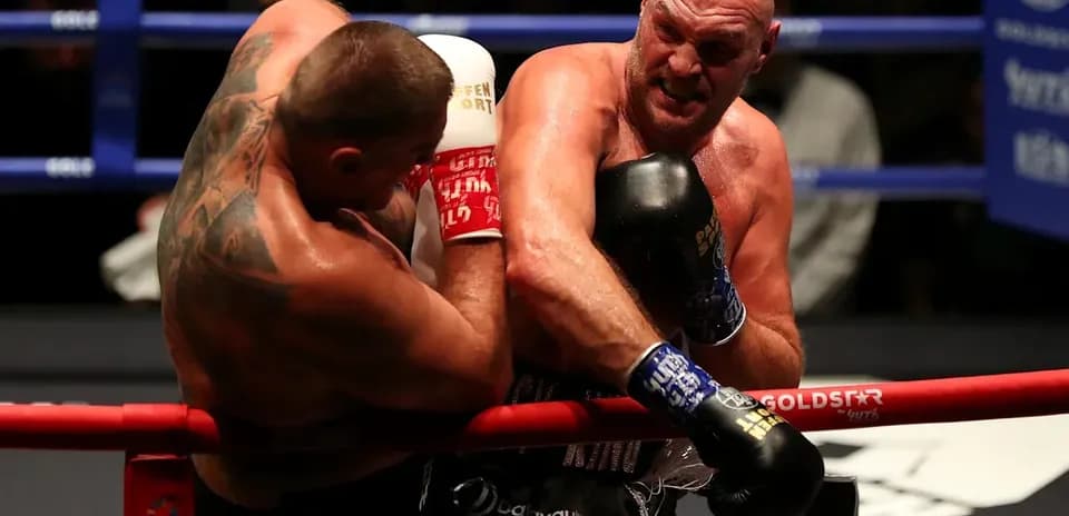 Two boxers exchanging punches in the ring