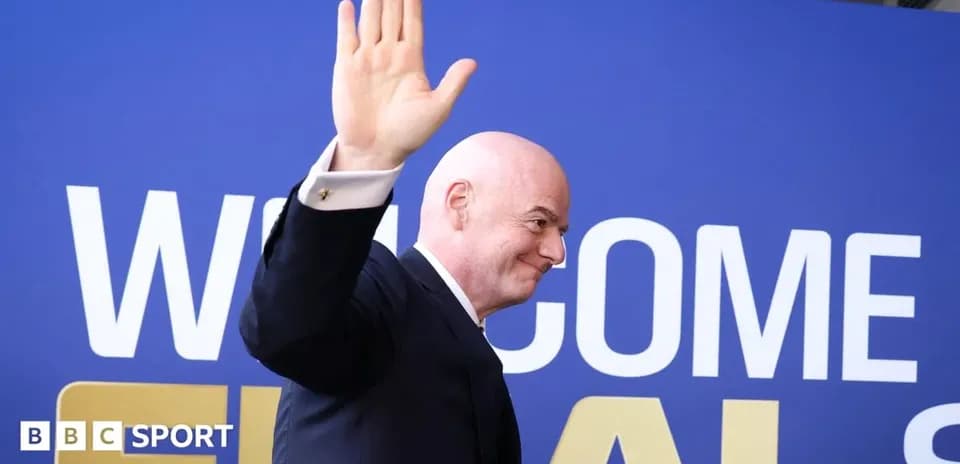 Official waving at event with welcome sign