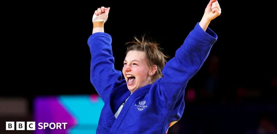 Judo athlete celebrating victory with raised arms