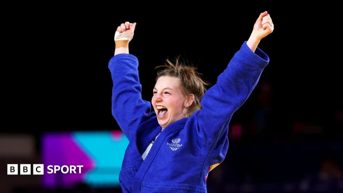 Judo athlete celebrating victory with raised arms
