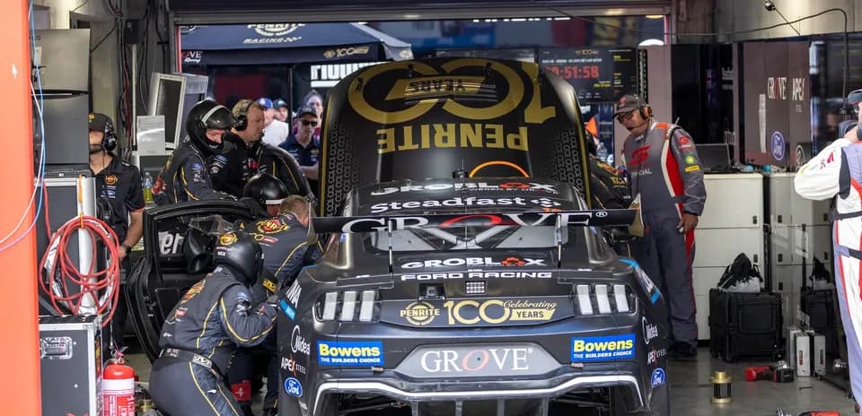Mechanics working on a race car in the garage