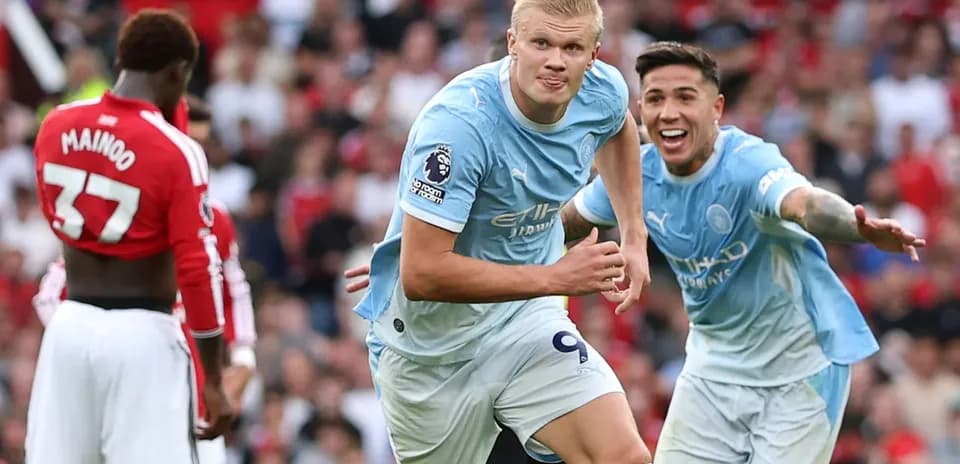 Manchester City players celebrating a goal on pitch