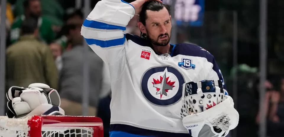 Hockey player adjusting helmet after game