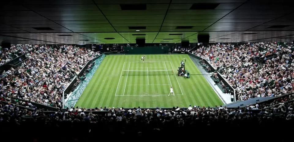 Tennis match at Wimbledon with large crowd