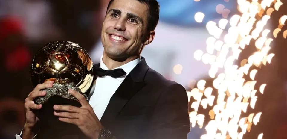 Player holding Ballon d'Or trophy during ceremony