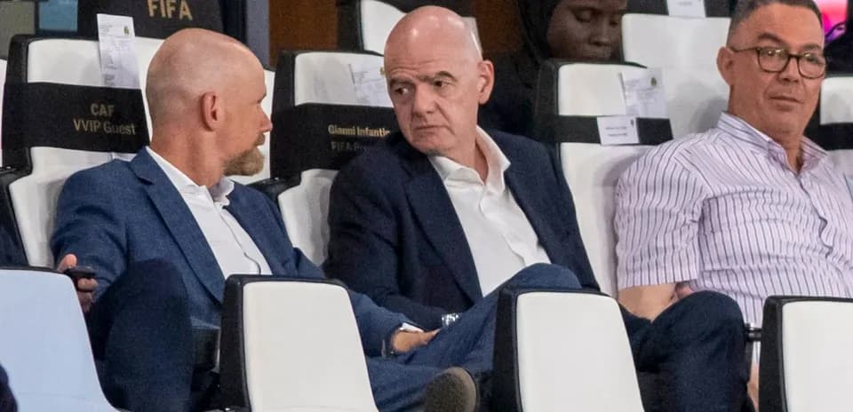 Three men seated in VIP area during event