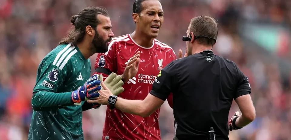 Liverpool players discussing with referee during match