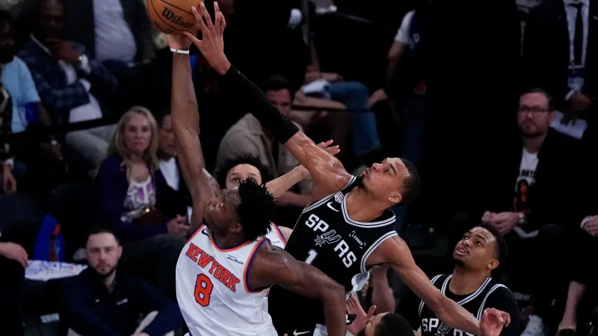 New York player attempting a shot against Spurs defense