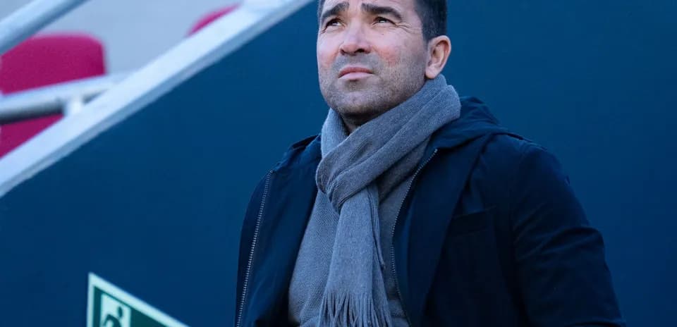 Person looking up while wearing a scarf outdoors