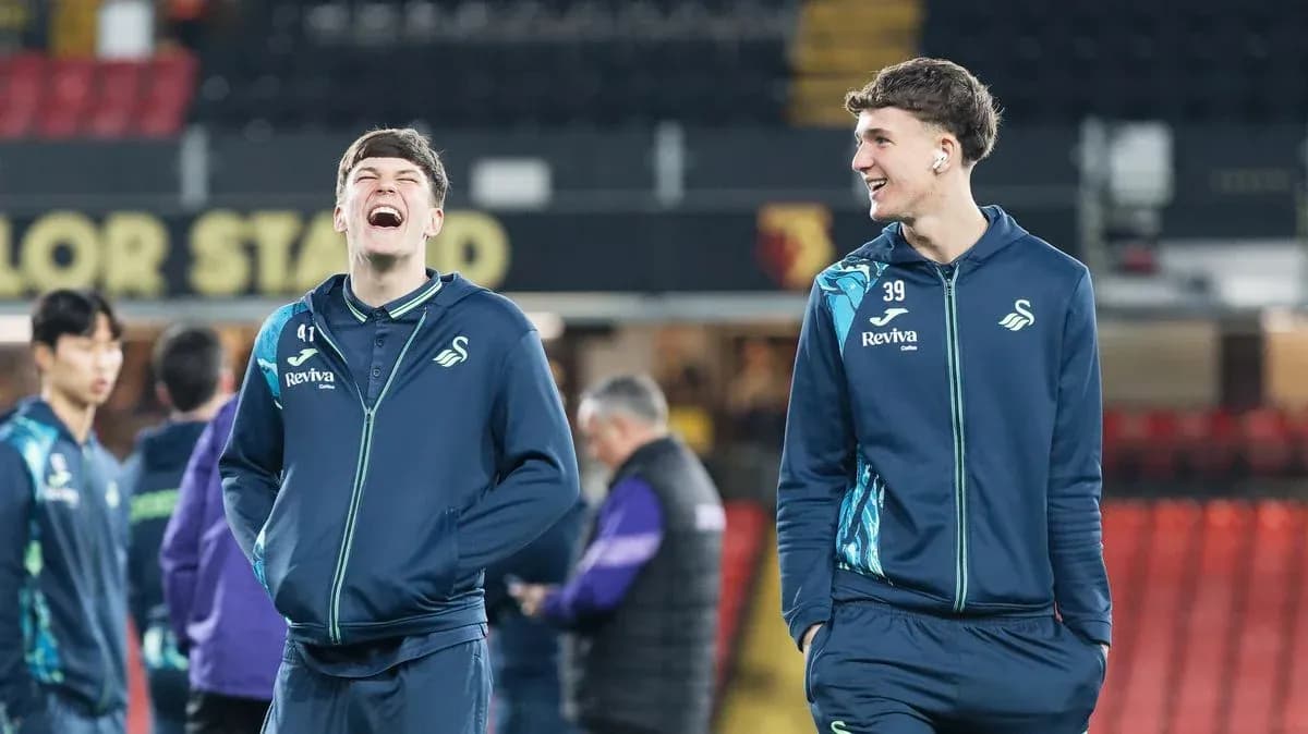 Swansea City players laughing during warm-up session