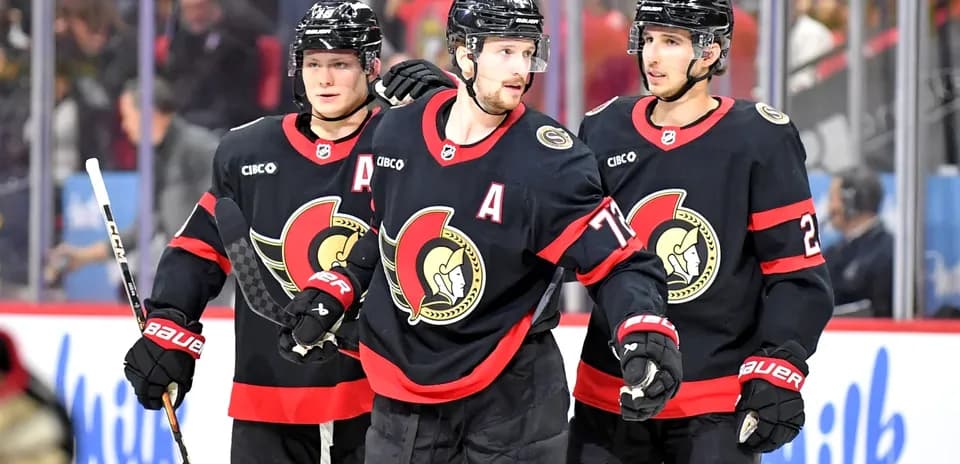 Three Ottawa Senators players celebrating on ice