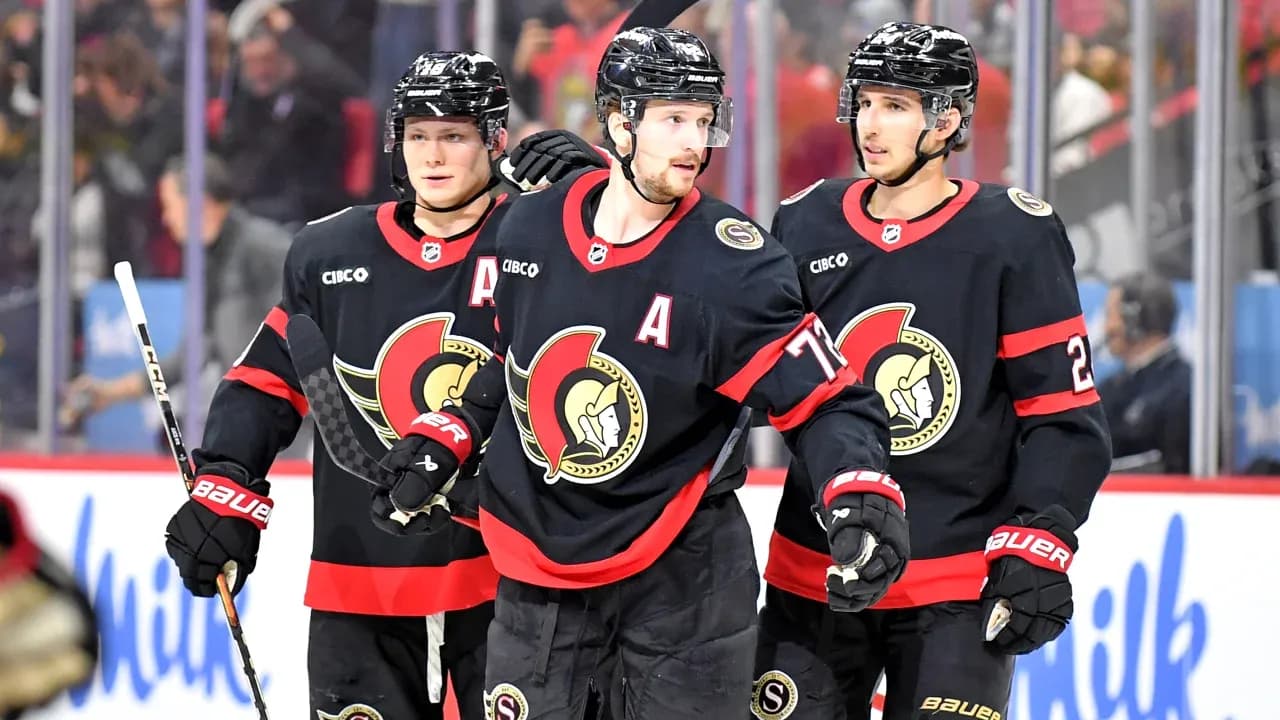 Three Ottawa Senators players celebrating on ice