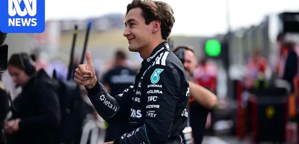 Pilot gesturing thumbs up in pit area