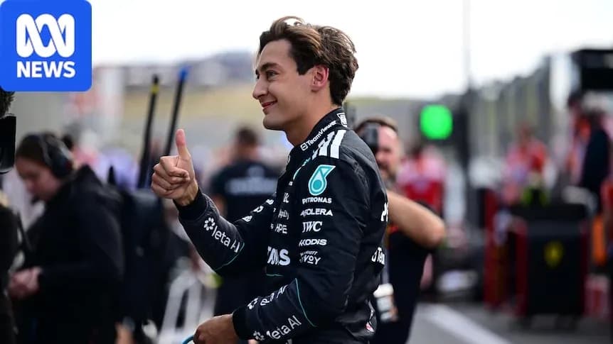 Pilot gesturing thumbs up in pit area