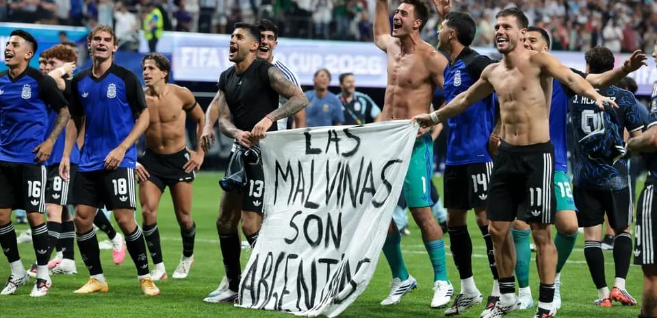 Argentina players celebrating with banner after match