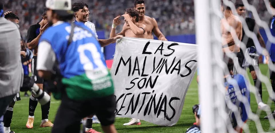 Players celebrating with a banner after match