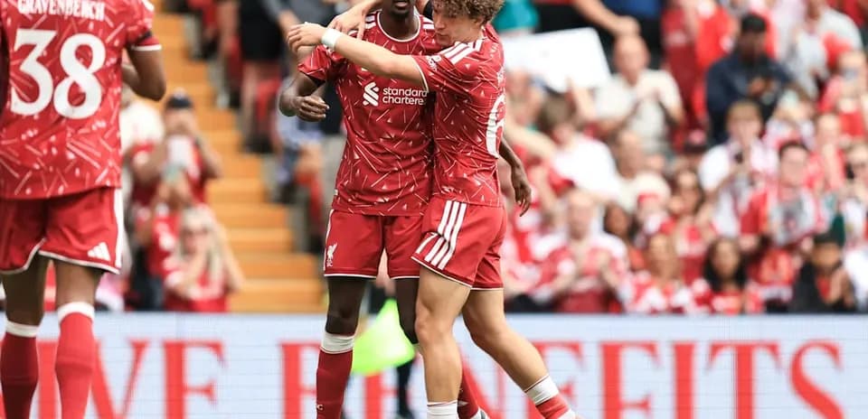 Liverpool players celebrating a goal on the pitch