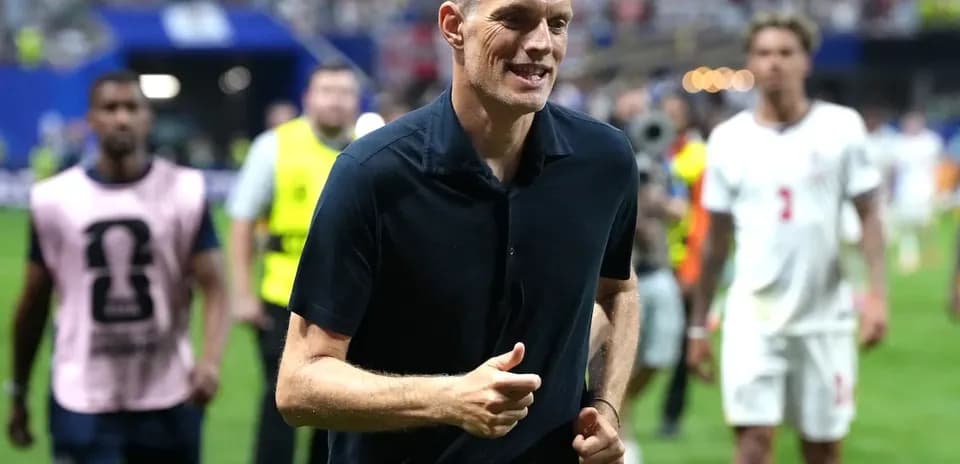 Coach walking on field after the match
