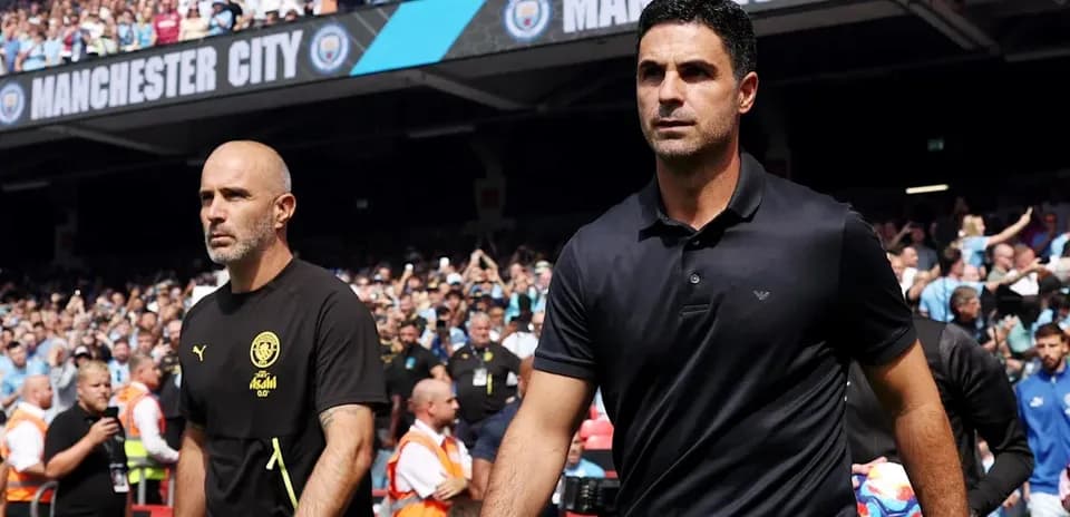 Coaches walking towards the pitch at Manchester City