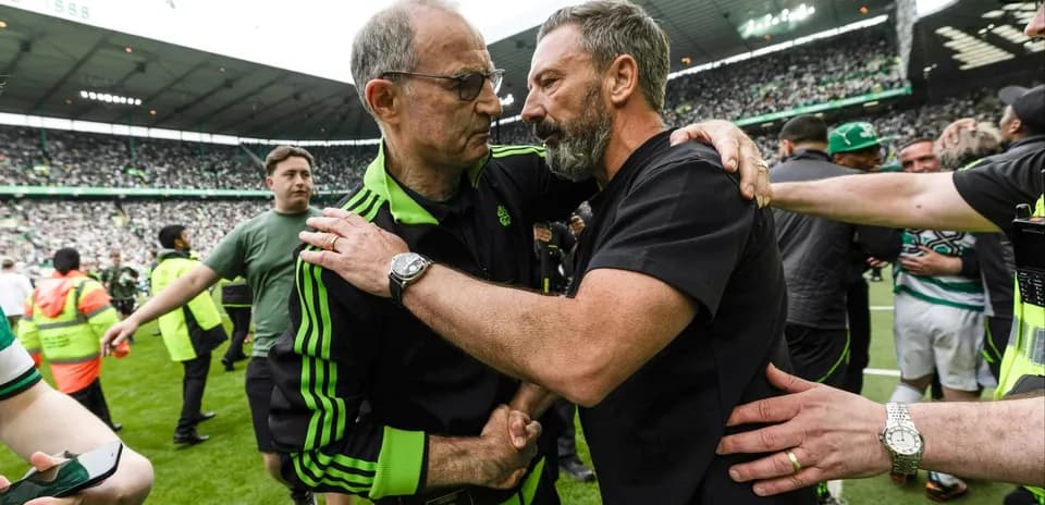 Trainers embracing on the pitch after match