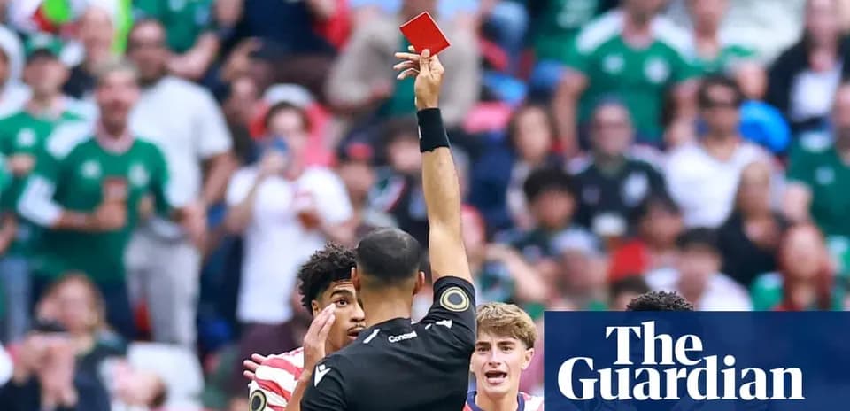 Referee showing red card to player during match