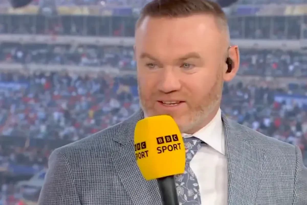 Analyst speaking on set with microphone at stadium